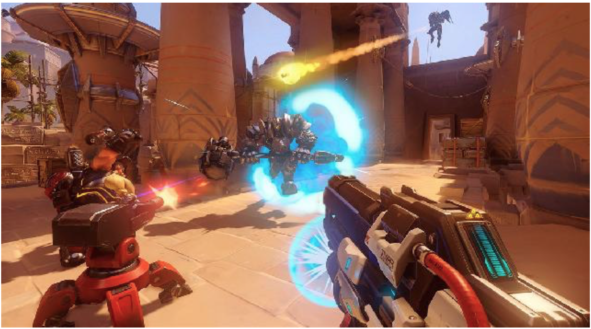 A first-person view of Overwatch gameplay, firing at a shielded enemy on a desert map.